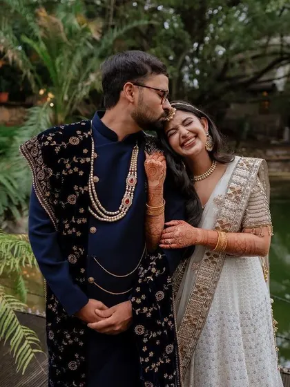 A tender moment during the sangeet night. The soft lighting and genuine smiles create a warm and romantic atmosphere, perfect for capturing the couple's love story.