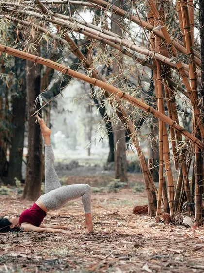 A variation of Setu Bandhasana, or Bridge Pose, in the forest. This gentle backbend is a great way to open the chest and strengthen the back, reminding us to trust that the dots will connect in our future.