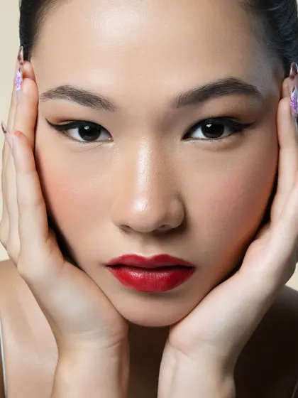 A perfect winged liner and a bold red lip are a classic combination for a reason. This close up shows the precision of the sharp cat eye, the rich pigment of the lip, and the smooth, perfected skin that serves as the ideal canvas.