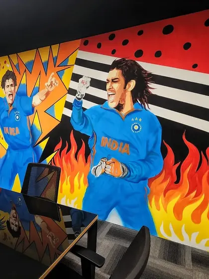 The final section of the conference room mural, featuring Sourav Ganguly and MS Dhoni against a backdrop of fire and abstract patterns.