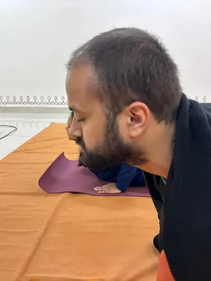 A close-up of a participant's focused expression during Surya Kriya, showing the deep involvement required.