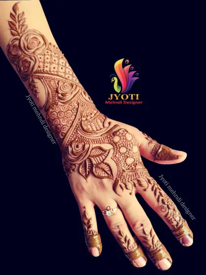 A beautiful Arabic-style design with heavy floral and rose motifs, perfect for a bride or for a special celebration. The detail extends up the arm.