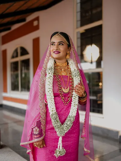 An elegant, smiling portrait of the bride. Her makeup is bright and fresh, perfect for a daytime wedding.