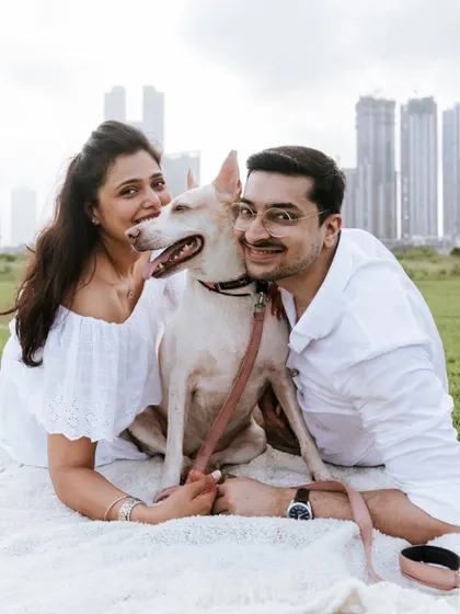 A fun, happy portrait with the Mumbai skyline in the background. Everyone, including the pup, is all smiles.