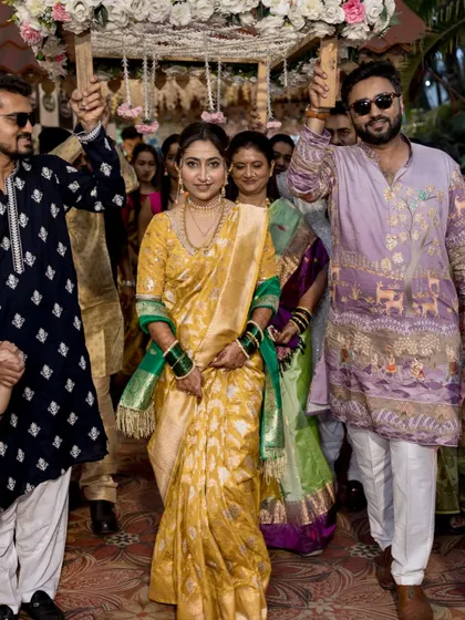 The bride making her grand entrance under a phoolon ki chadar.
