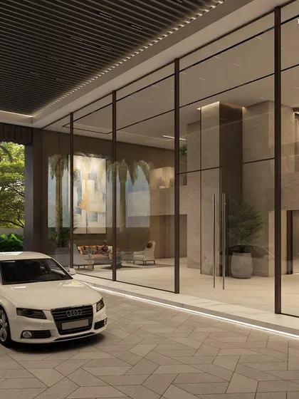 The grand entrance to our luxury destination in Worli. The driveway and lobby are marked by majestic heights and crafted from the finest materials, including expansive glass walls, to elevate the sense of refined grandeur.