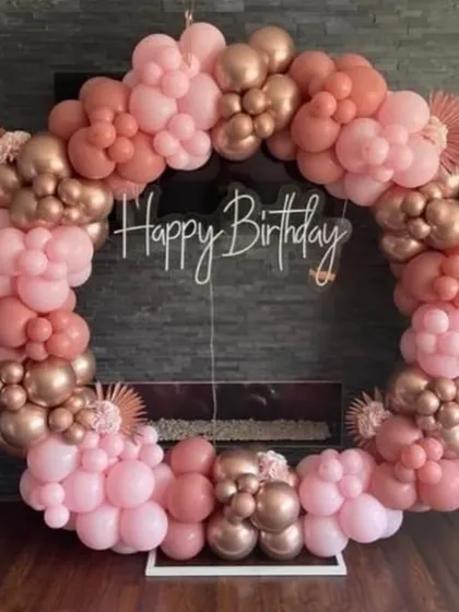 A close-up of the elegant dusty rose and rose gold balloon ring. The different sizes and shades of balloons create a beautiful texture and depth.