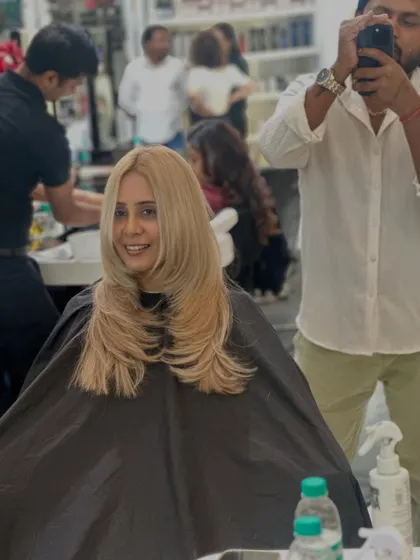 A stunning, sleek blonde look. This layered cut is designed to be styled pin-straight to show off the clean lines and the beautiful, bright color.