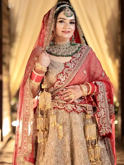 A full-length portrait of the bride, highlighting the intricate work on her lehenga and the flawless execution of her makeup and hair.
