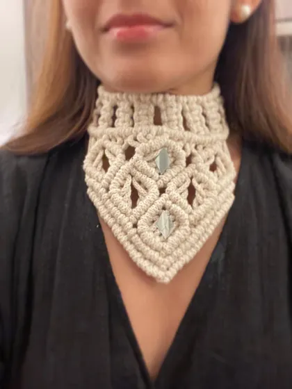 Here is the collar necklace paired with a simple black top. It instantly elevates the look, adding a touch of bohemian flair. The neutral ivory color makes it easy to style with anything.