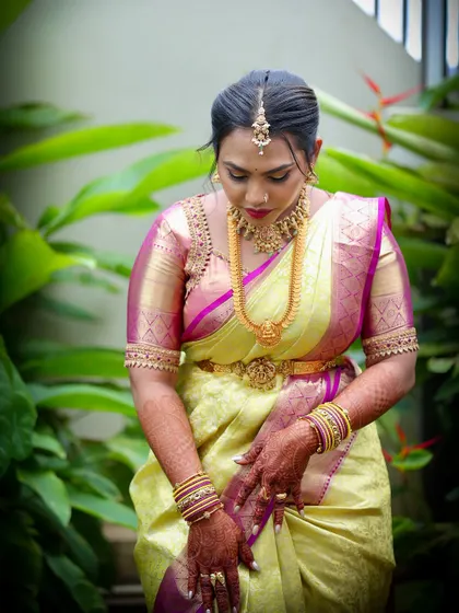 Another view of the beautiful lime green Kanjeevaram saree, highlighting the intricate border and the custom-fit of the matching blouse.