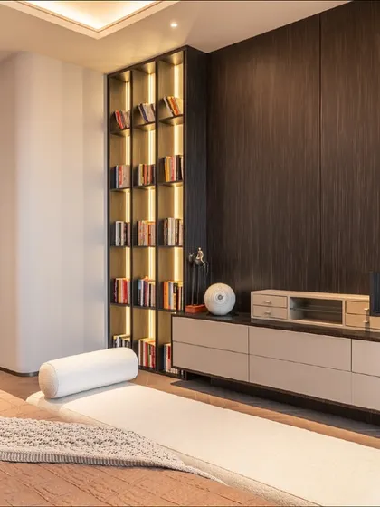 A view of the custom cabinetry and shelving in the master bedroom. The dark wood veneer and integrated lighting create a sophisticated storage and display solution.