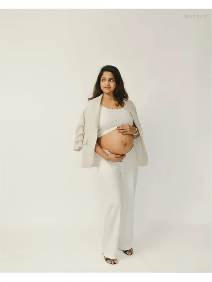 A confident and beautiful pose from a modern maternity session. The open blazer elegantly frames her baby bump.