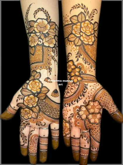 The full view of the asymmetrical floral design. This image clearly shows how the two different styles on each hand create a unique and personalized bridal look.