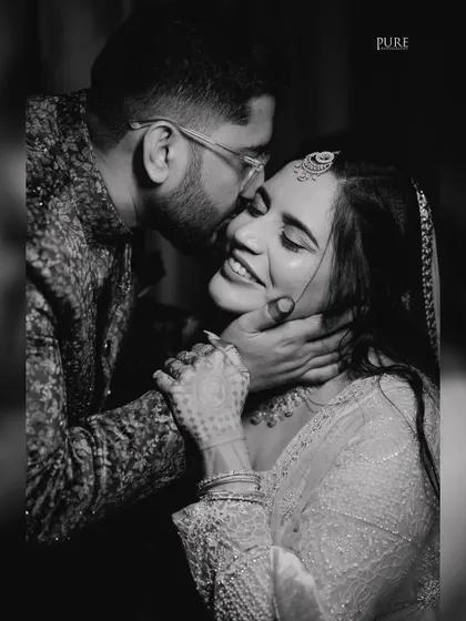 A beautiful black and white shot capturing a moment of pure happiness and affection between the newly engaged couple.