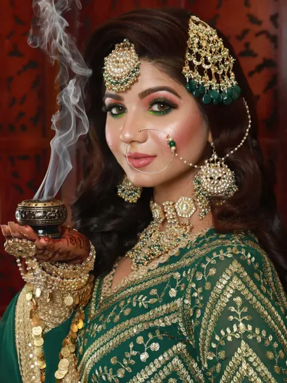 I love adding a touch of drama and artistry to my looks. This creative bridal portrait uses smoke to create a mystical effect, highlighting the rich green tones of the lehenga and the sharp, defined eye makeup.