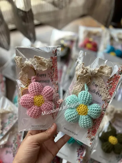 Our puff flower keychains are perfect for gifting. Here they are, beautifully packaged with "Happy Birthday" and "Happy Anniversary" cards. It's a thoughtful, handmade gift ready to go.