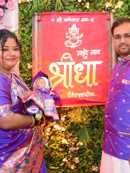 A classic portrait of the family with their newborn at the naming ceremony.