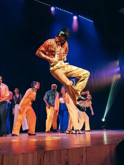 A dancer caught mid-air, showcasing the high energy and authentic moves of our 70s-inspired Soul & Locking piece.