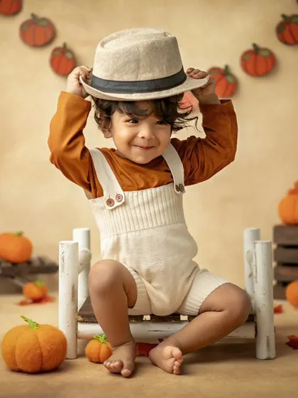 My cute little pumpkin! This autumn-themed shoot with a pumpkin patch setup is perfect for celebrating the season.