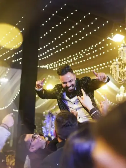 The groom celebrating with his friends on the dance floor. We capture the energy and fun of the sangeet night from every angle.