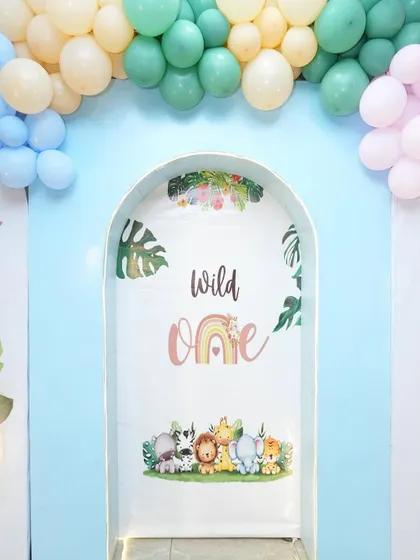 A detail of the 'Wild One' backdrop, featuring a cute rainbow and animal illustrations.