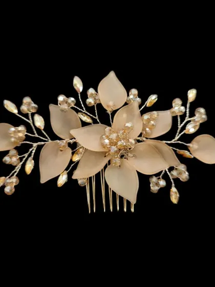 An elegant hair brooch or comb with translucent blush-pink flowers and sparkling crystal branches. This is a sophisticated choice for a reception or engagement hairstyle.