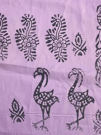 A fabric sample showing a combination of different block print motifs, including birds and floral borders. This shows how different blocks can be used together to create a scene.