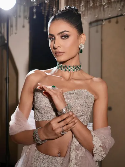 This shot captures the modern, edgy vibe of the look. The sculpted glam makeup and high-shine jewels make for an unforgettable and powerful statement.