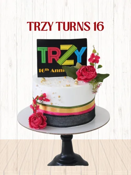 A vibrant and festive cake for Trzy's 16th anniversary. This design includes the company's colorful logo on a topper, complemented by fresh flowers and coordinating ribbons.