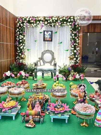 A wide view of a beautiful Seemantham decor in a modern home. The contrast between the wood-paneled walls and the fresh floral arch creates a warm and inviting space for the ceremony.
