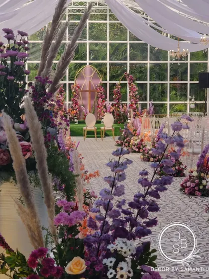 The aisle was adorned with beautiful arrangements of lilac, peach, and white flowers, creating a fragrant and visually stunning path for the bride.