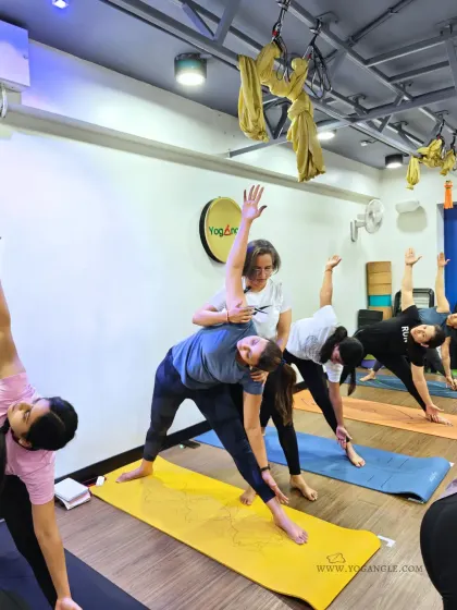 An instructor provides a hands on adjustment during our Women's Health Workshop. These specialized events allow us to dive deeper into topics and provide personalized guidance in a supportive setting.