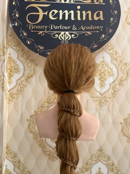 A bubble braid created with an inner micro-braid for added texture. This is a detailed look at one of the modern braid styles we teach.