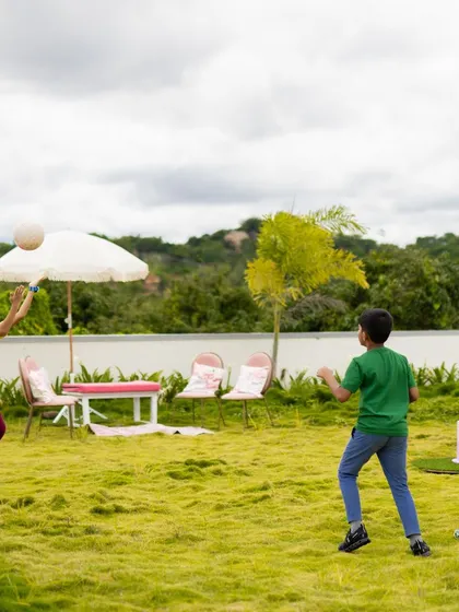 Boys playing with a ball in a spacious outdoor party area. I always ensure there's plenty of room for free play and running around.