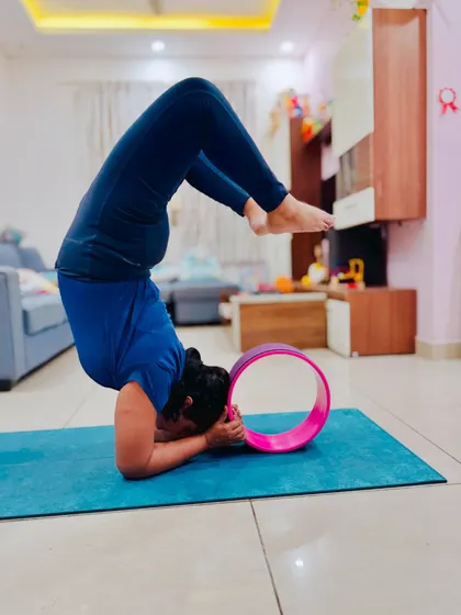Using a yoga wheel for support in Scorpion Pose is a great way to build confidence and understand the alignment. It's not perfect, but I am trying my best to deepen the backbend.