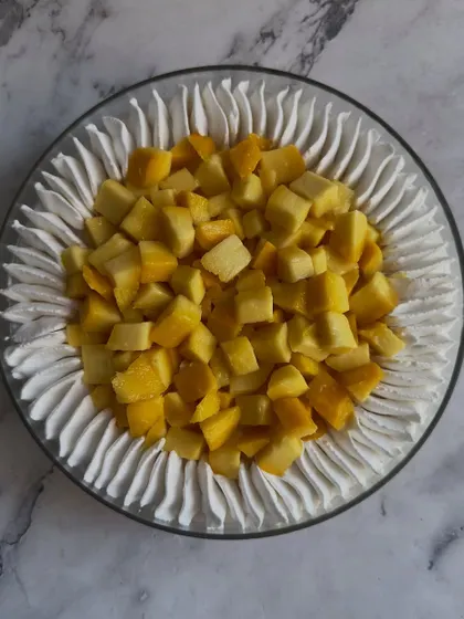 This is my Mango Tres Leches, a super soft sponge cake soaked in a sweet milk mixture and topped with fresh, diced mangoes. It's an authentic and refreshing dessert.