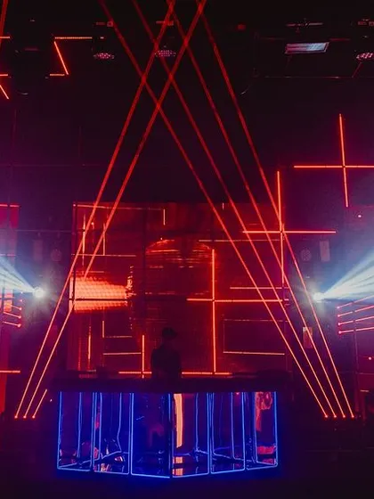 The main stage and DJ booth, featuring a massive grid of programmed laser lights and strobes. The light show was synchronized with the music to create an authentic techno club experience.