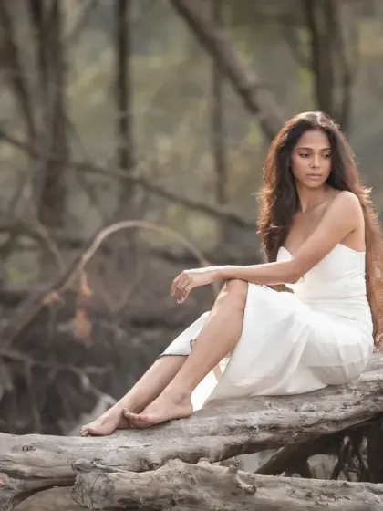 A soft and serene portrait from a bridal editorial shoot. The muted tones of the forest and the model's gentle pose create a peaceful and beautiful image.