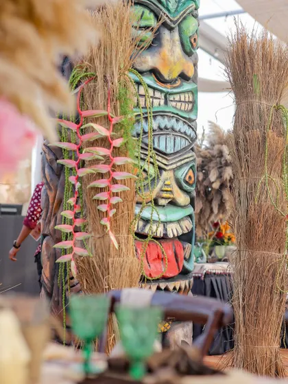 Another close-up of a colorful Tiki statue, with its expressive face and intricate carvings. These pieces were custom-made to bring the Polynesian theme to life.
