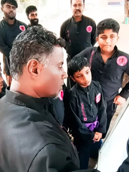 Theory is as important as practice. Here, I am explaining concepts to a group of young students, ensuring they understand the 'why' behind the 'how'.
