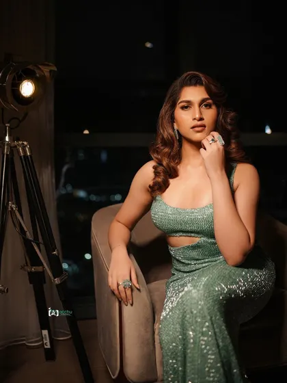 This angle focuses on the confident expression and the sparkle of the dress. It’s a powerful seated portrait that commands attention, perfect for a personal branding or fashion shoot.