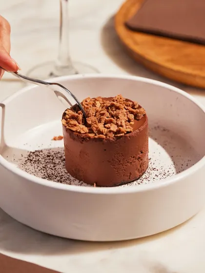 A fork cuts into the smooth, rich texture of our Bitter Choco Mousse.