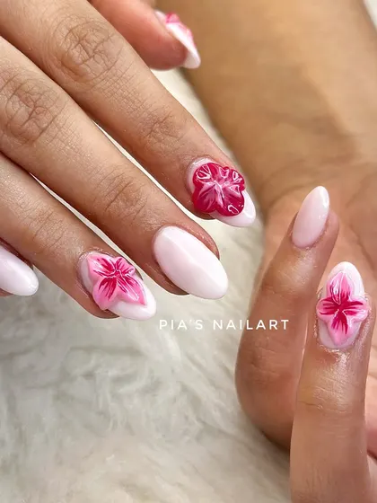 Trending 3D jelly flowers on a milky white base. These flowers are encapsulated within the nail, giving them a unique, translucent effect that is super popular right now.