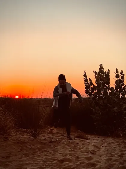 A candid shot of me running through the sand dunes of Rajasthan at sunset.