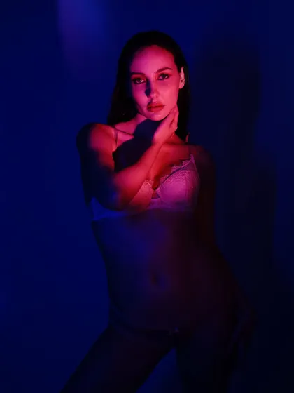A duplicate of image 95, showcasing a powerful pose that uses colored light to create a strong, graphic silhouette.