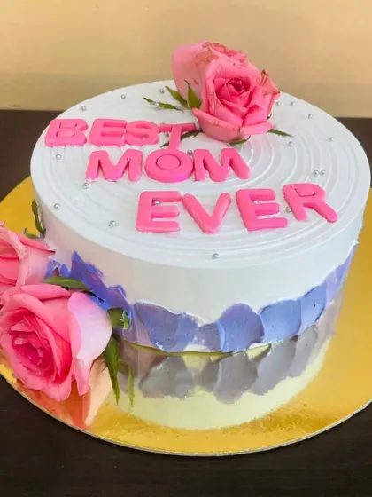 A beautiful cake for the "Best Mom Ever," featuring floral decorations and a lovely color palette.