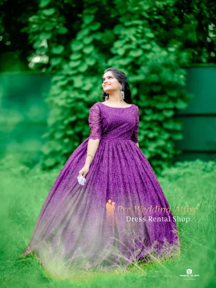 The purple lace ball gown looks ethereal in this soft, natural lighting. The subtle texture of the fabric adds depth and interest.