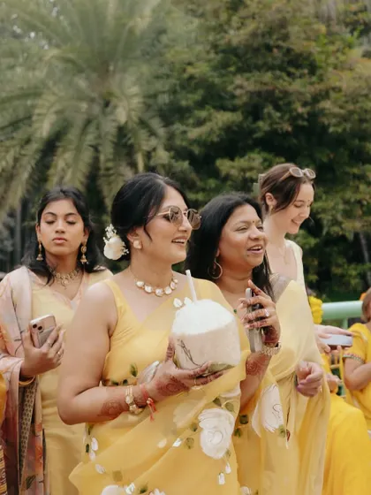 Guests enjoying the personalized coconut bar at a summer Haldi. It's these unique touches that make the guest experience memorable and special.