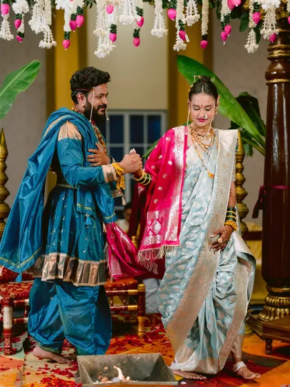 The couple taking their vows around the sacred fire during their traditional wedding.